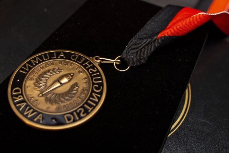 medal reading "Distinguished Alumni Award"